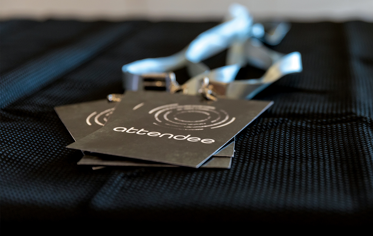 Close up photo of lanyards bearing conference logo