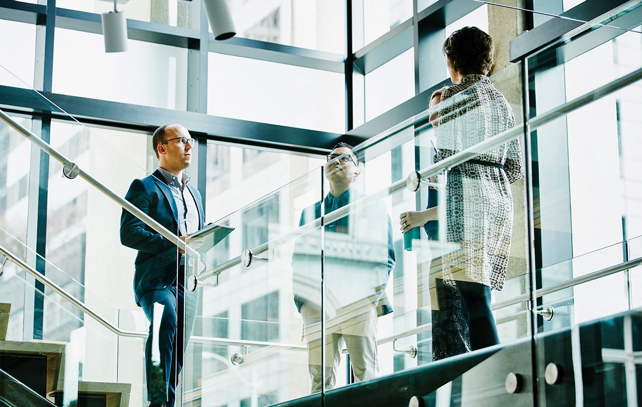 Business colleagues in discussion on office stairs