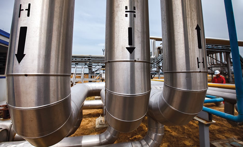 Oil refinery and gas processing plant in desert. Hydrogen sign. Technological tubes and pipelines. Close-up.