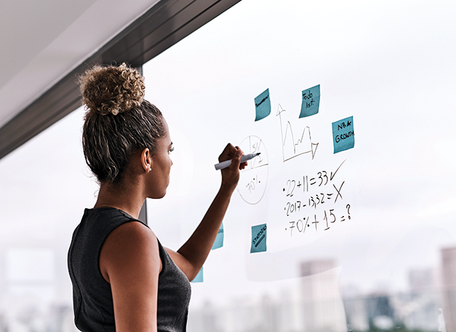 Business woman writing on window