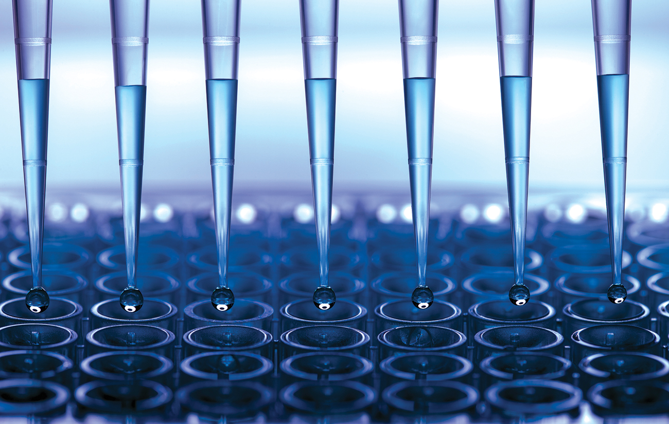 Blue pipettes filling test tubes