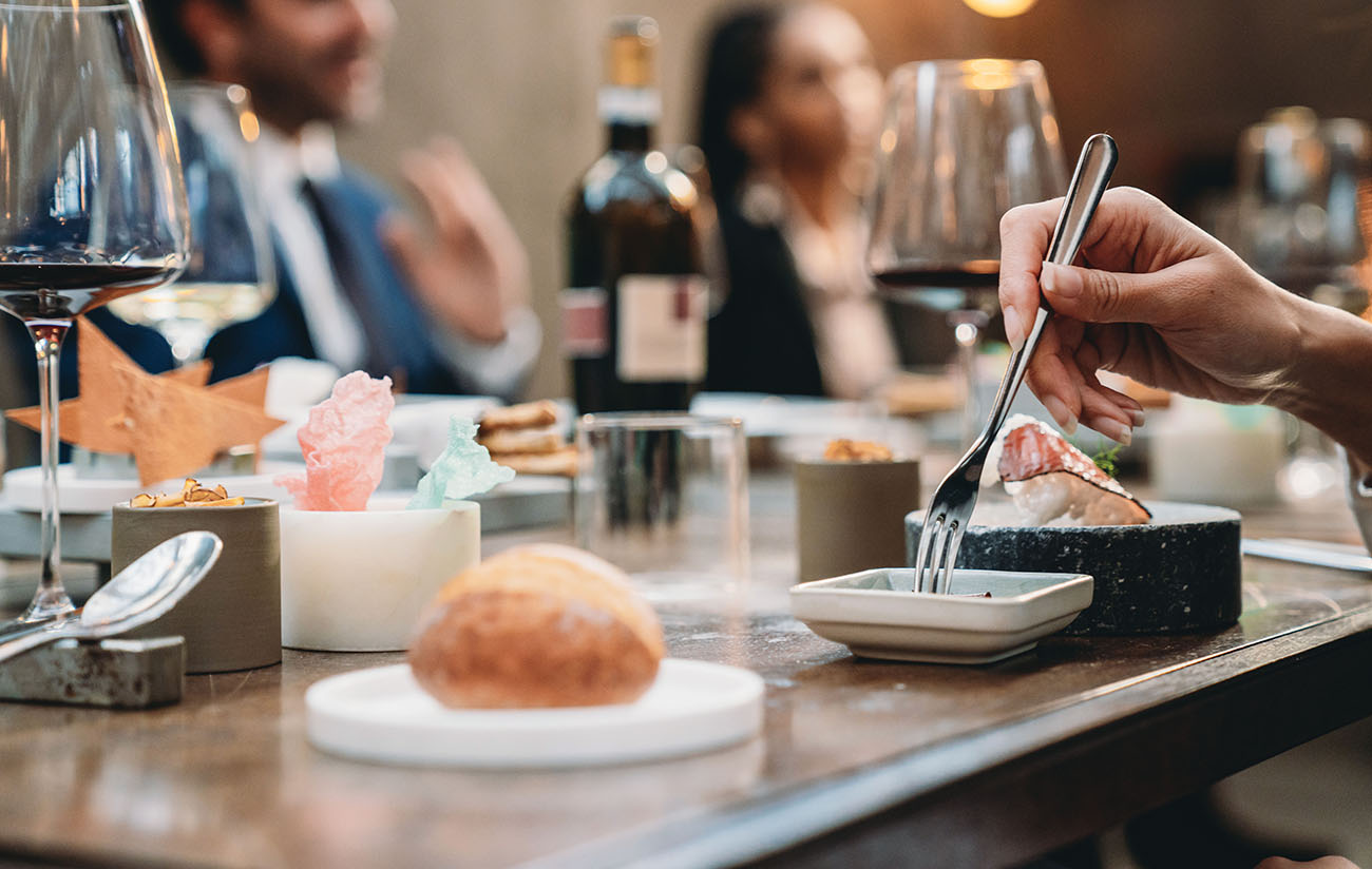 Close-up shot on a hand with a fork in a restaurant