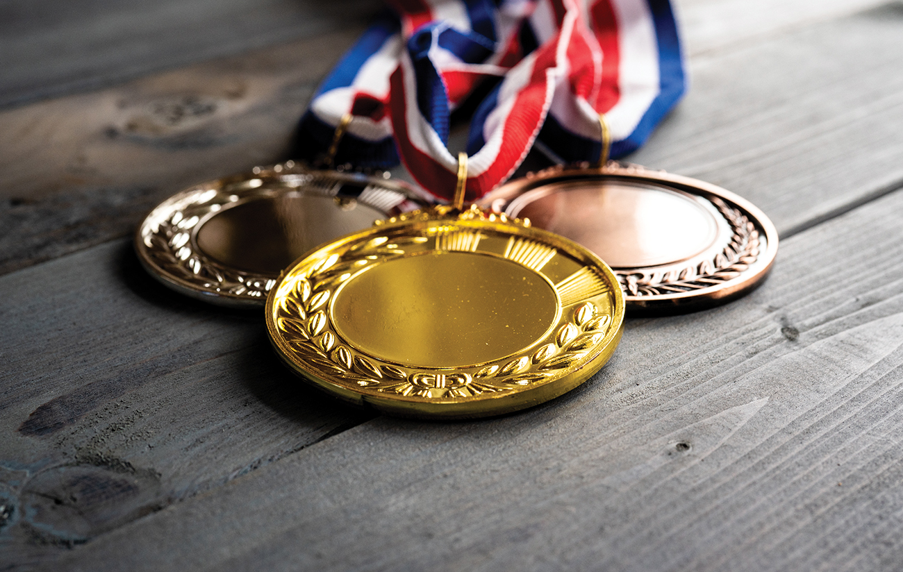 Gold silver and bronze medal on table