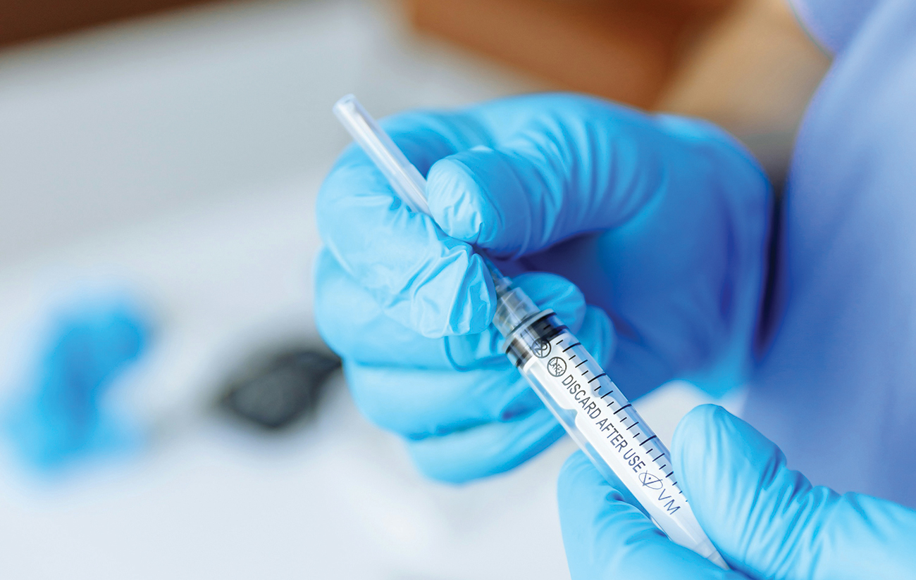 Medical personnel with syringe