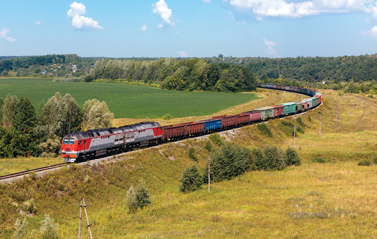 Powerful diesel locomotive with freight train