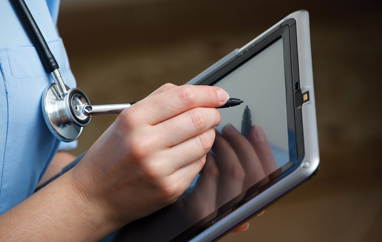 Healthcare professional holding a tablet