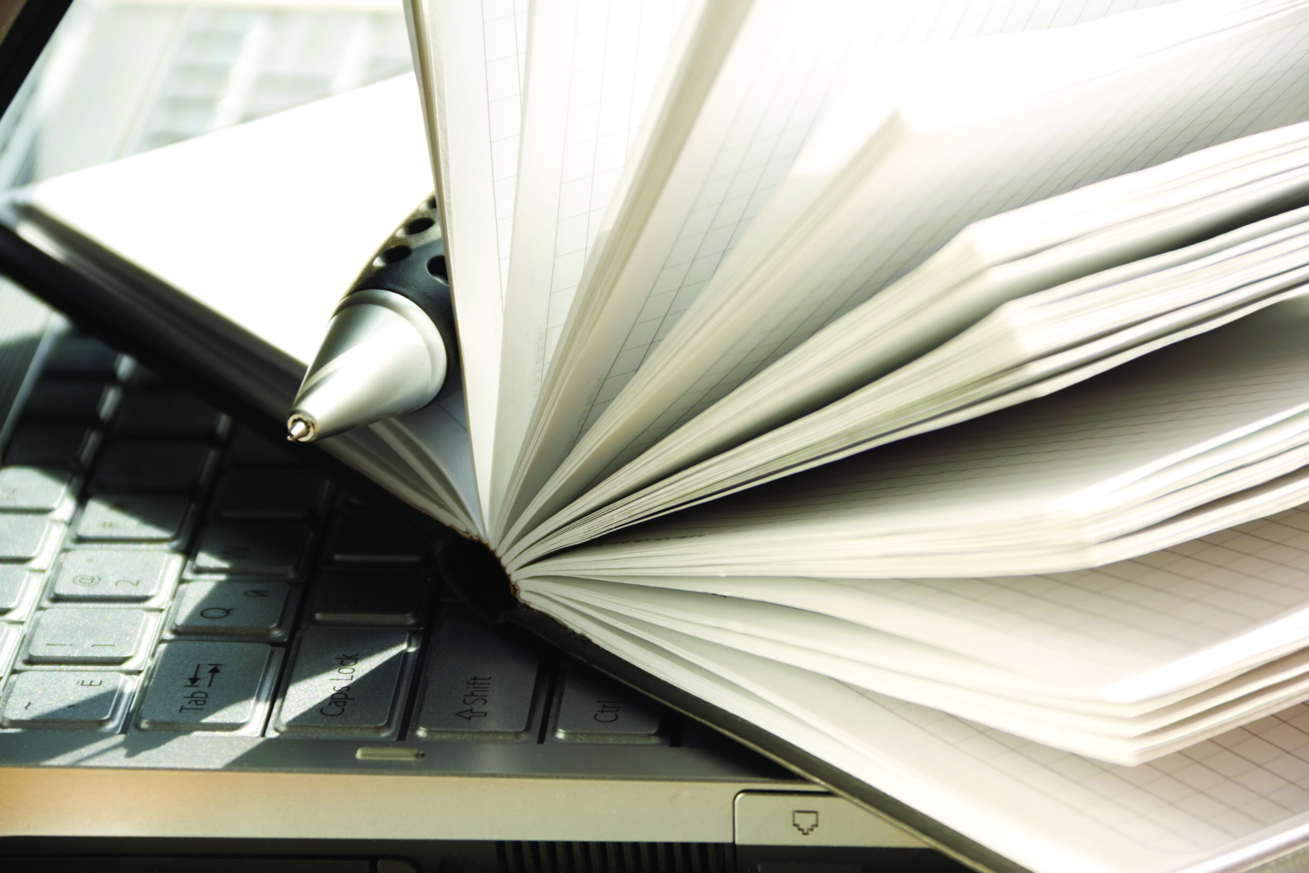 Laptop-open-notebook-pen-hr-scaled